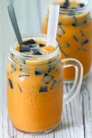 Thai-Iced-Milk-Tea-with-Grass-Jelly-front-view-in-two-mason-mugs-with-boba-straws-and-tall-silver-spoons.jpg