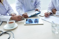 three-cropped-doctors-analyzing-chest-x-ray-digital-pad.jpg